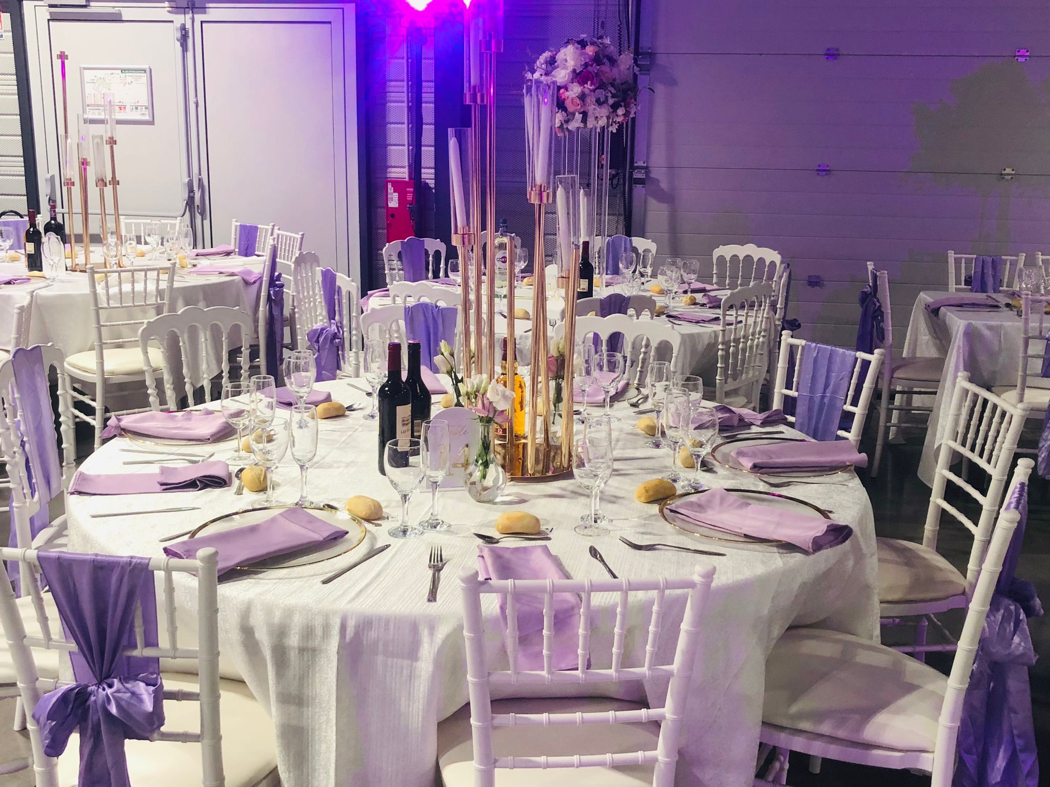 Table de réception blanche et violette avec compositions florales